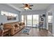 Inviting living room featuring a comfortable leather sofa and sliding glass doors to the balcony at 8409 Placida Rd # 305, Placida, FL 33946