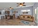Open-concept living room and dining area with sliding glass doors to the balcony at 8409 Placida Rd # 305, Placida, FL 33946