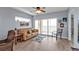 Bright living room with balcony access is well-lit by a ceiling fan at 8409 Placida Rd # 305, Placida, FL 33946