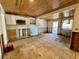 Bright kitchen featuring wood ceiling, access to porch, and walls and floor needing renovation at 8896 Gulf St, Placida, FL 33946