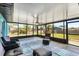 This screened-in sunroom features plenty of seating and views to the backyard at 9040 Everington Rd, Englewood, FL 34224