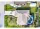 Overhead view showcases a home with a pool and surrounding greenery at 9260 Saint Catherine Ave, Englewood, FL 34224