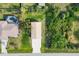 Aerial view of home and its backyard featuring an in-ground pool with screened enclosure and lush landscaping at 9260 Saint Catherine Ave, Englewood, FL 34224