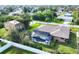 Overhead view shows the pool enclosure and the house situated in its residential neighborhood at 9260 Saint Catherine Ave, Englewood, FL 34224