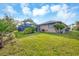 Lush backyard featuring a private screened-in pool at 9260 Saint Catherine Ave, Englewood, FL 34224