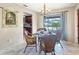 Cozy dining area with seating for four, chandelier, and sliding doors leading to the patio at 9260 Saint Catherine Ave, Englewood, FL 34224
