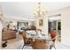 Dining area adjacent to the living room and kitchen, features seating for four and neutral decor at 9260 Saint Catherine Ave, Englewood, FL 34224