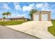 Exterior shot of home, oversized garage, and well maintained lawn at 9260 Saint Catherine Ave, Englewood, FL 34224