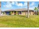 Charming single-story home featuring a well-manicured lawn, stone accents, and a two-car garage at 9260 Saint Catherine Ave, Englewood, FL 34224