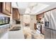 Modern kitchen featuring stainless-steel appliances, stylish backsplash, and open access to the dining area at 9260 Saint Catherine Ave, Englewood, FL 34224