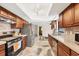 Modern kitchen with stainless steel appliances, wood cabinets, and tile floors at 9260 Saint Catherine Ave, Englewood, FL 34224
