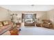 Bright living room featuring neutral walls, carpeted floors, and large windows providing plenty of natural light at 9260 Saint Catherine Ave, Englewood, FL 34224