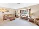Bright living room with plush seating, decorative accents, and a large window for ample natural light at 9260 Saint Catherine Ave, Englewood, FL 34224