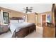 A spacious main bedroom features a large bed, ceiling fan and an ensuite bathroom at 9260 Saint Catherine Ave, Englewood, FL 34224