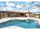 Gorgeous screened-in pool with relaxing patio and backyard views at 9260 Saint Catherine Ave, Englewood, FL 34224