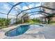 Sparkling in-ground pool surrounded by a screened enclosure at 9260 Saint Catherine Ave, Englewood, FL 34224