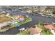 Aerial view of a waterfront community with canals, docks, and beautiful homes at 9382 Rosebud Cir, Port Charlotte, FL 33981