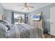 Light-filled main bedroom with a plush bed, light wood furnishings, and water views at 9382 Rosebud Cir, Port Charlotte, FL 33981