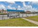 View of a covered boat lift, dock, and waterfront access on a sunny day at 9382 Rosebud Cir, Port Charlotte, FL 33981