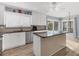 Bright kitchen boasts white cabinets, stainless steel appliances, granite countertops and an island at 9382 Rosebud Cir, Port Charlotte, FL 33981