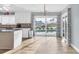 Bright kitchen featuring an island, white cabinets and natural light filled views of the pool at 9382 Rosebud Cir, Port Charlotte, FL 33981