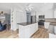 Well-lit kitchen featuring an island, granite countertops, and stainless steel appliances at 9382 Rosebud Cir, Port Charlotte, FL 33981