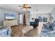 Inviting living room with hardwood floors, coastal furnishings, and an open layout at 9382 Rosebud Cir, Port Charlotte, FL 33981