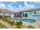 Beautiful pool area with view of the screened in lanai. Well landscaped with rock features at 9382 Rosebud Cir, Port Charlotte, FL 33981