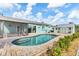 Backyard pool area with attached lanai, shed, and lush landscaping. Ideal for outdoor fun and relaxation at 9382 Rosebud Cir, Port Charlotte, FL 33981