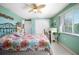 Bright bedroom with tropical bedspread and coordinating dresser at 980 Manor Rd, Englewood, FL 34223