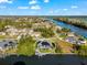 Aerial view of a solar panel home with a screened pool on a waterfront canal in a residential neighborhood at 10491 Sarasota Rd, Port Charlotte, FL 33981