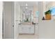 Well-lit bathroom with a granite countertop, white cabinetry, and ample mirror space at 10491 Sarasota Rd, Port Charlotte, FL 33981
