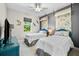 Bright bedroom with two twin beds, stylish decor, and a view of the outdoors at 10491 Sarasota Rd, Port Charlotte, FL 33981
