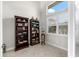 A cozy den features plantation shutters, tile floors, and two full-size bookcases at 10491 Sarasota Rd, Port Charlotte, FL 33981