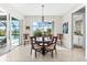 Elegant dining area with a round table, stylish chairs, and views of the pool area at 10491 Sarasota Rd, Port Charlotte, FL 33981