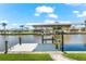 Private boat dock with boat lift on the water's edge, enhanced by green grass and blue skies at 10491 Sarasota Rd, Port Charlotte, FL 33981
