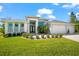 Well-kept lawn and landscaping accentuates the front of this contemporary home with a three-car garage at 10491 Sarasota Rd, Port Charlotte, FL 33981