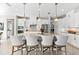 Stylish kitchen with a center island, pendant lights, and ample cabinet space at 10491 Sarasota Rd, Port Charlotte, FL 33981