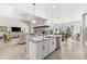 Modern kitchen with an island, pendant lighting, and views of the living and dining areas at 10491 Sarasota Rd, Port Charlotte, FL 33981