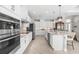 Well-equipped kitchen with stainless steel appliances, white cabinetry, and a center island at 10491 Sarasota Rd, Port Charlotte, FL 33981