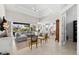 Open-concept living room with high ceilings, tile floors, and natural light flowing in from large windows at 10491 Sarasota Rd, Port Charlotte, FL 33981