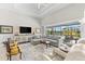 Open living room with plush seating, neutral tones, and views of the pool area at 10491 Sarasota Rd, Port Charlotte, FL 33981