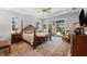 Spacious main bedroom featuring a four-poster bed, ceiling fan, and sliding glass doors to an outdoor space at 10491 Sarasota Rd, Port Charlotte, FL 33981