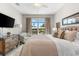 Tranquil main bedroom with water views, ceiling fan, and neutral color scheme at 10491 Sarasota Rd, Port Charlotte, FL 33981