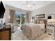 Serene main bedroom with sliding glass doors, a ceiling fan, and a calming color palette at 10491 Sarasota Rd, Port Charlotte, FL 33981
