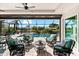 Inviting screened patio with waterfront view features comfortable seating and a ceiling fan at 10491 Sarasota Rd, Port Charlotte, FL 33981