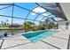 A sunny screened in pool area with stone tile, waterfront views and a relaxing atmosphere at 10491 Sarasota Rd, Port Charlotte, FL 33981