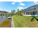Screened in porch and lawn leading to a private dock with a covered boat lift on waterfront property at 10491 Sarasota Rd, Port Charlotte, FL 33981