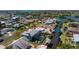 Aerial view of the property featuring a pool with a screen, surrounded by a canal and lush landscaping at 1052 Newton St, Englewood, FL 34224