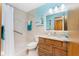 Bright bathroom with tiled shower, updated vanity, and nautical decorations at 1052 Newton St, Englewood, FL 34224
